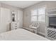 Comfortable bedroom featuring a white dresser and chair bathed in natural light at 4105 S Ocean Blvd. # 102, North Myrtle Beach, SC 29582