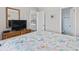 Bedroom with TV, a view of the kitchen and bathroom and a patterned bedspread at 4105 S Ocean Blvd. # 102, North Myrtle Beach, SC 29582