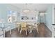 Charming dining area featuring a light wood table, wicker chairs, and a view into the kitchen at 4105 S Ocean Blvd. # 102, North Myrtle Beach, SC 29582