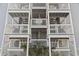 View of the condo with multiple levels of decks with white railings and stairs at 4105 S Ocean Blvd. # 102, North Myrtle Beach, SC 29582