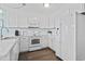 Bright kitchen featuring white cabinets, white appliances, and wood-look flooring at 4105 S Ocean Blvd. # 102, North Myrtle Beach, SC 29582