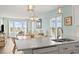 Bright open concept kitchen featuring white counters and cabinets with an adjacent living room and ocean view at 4105 S Ocean Blvd. # 102, North Myrtle Beach, SC 29582