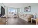 Comfortable living room features hardwood floors and lots of natural light with beach view at 4105 S Ocean Blvd. # 102, North Myrtle Beach, SC 29582