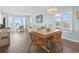 Inviting living room featuring wicker chairs, wood floors, a dining table, and ocean views at 4105 S Ocean Blvd. # 102, North Myrtle Beach, SC 29582
