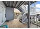 Outdoor porch featuring gray stairs, an exit door, and outdoor seating, perfect for relaxing at 4105 S Ocean Blvd. # 102, North Myrtle Beach, SC 29582