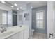 Well-lit bathroom with dual sinks, tile flooring, and ample natural light from multiple windows at 4162 Dupree Dr., Little River, SC 29566