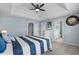 Bright bedroom featuring a coastal theme with a large bed and access to an ensuite bathroom at 4162 Dupree Dr., Little River, SC 29566