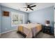 Inviting bedroom with a window, neutral walls, ceiling fan, and matching bedside tables at 4162 Dupree Dr., Little River, SC 29566