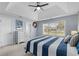 Bright bedroom featuring a tray ceiling, ceiling fan, and a large window with neighborhood views at 4162 Dupree Dr., Little River, SC 29566