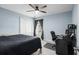 Cozy bedroom with a bed, desk, ceiling fan and a window bringing in natural light at 4162 Dupree Dr., Little River, SC 29566