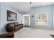 Bright and airy living room with large window, beach-themed artwork and comfortable seating at 4162 Dupree Dr., Little River, SC 29566