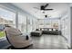 Bright sunroom with lots of windows providing natural light and a massage chair at 4162 Dupree Dr., Little River, SC 29566