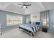 Comfortable main bedroom with a tray ceiling and lots of natural light at 4162 Dupree Dr., Little River, SC 29566
