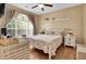 Bright bedroom with a large window, stylish curtains, light walls, and ceiling fan at 4221 Hibiscus Dr. # 8-203, Little River, SC 29566