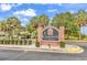 The Gardens at Cypress Bay sign with lush landscaping and palm trees at 4221 Hibiscus Dr. # 8-203, Little River, SC 29566