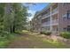 Exterior view of a building with screened patios and trees in a community at 4221 Hibiscus Dr. # 8-203, Little River, SC 29566