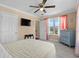 Charming bedroom featuring a ceiling fan, neutral walls, and bright window with curtains at 4387 Landing Rd., Little River, SC 29566