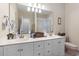 Bathroom with dual sinks, white cabinets, and a large mirror over the vanity at 4691 Mill Pond Rd., Murrells Inlet, SC 29576