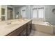 Bright bathroom with a double sink vanity, shower, soaking tub, and ample natural light at 4691 Mill Pond Rd., Murrells Inlet, SC 29576