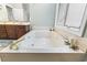 Relaxing soaking tub with jets, a gold faucet and plenty of natural light, for a spa-like experience at 4691 Mill Pond Rd., Murrells Inlet, SC 29576