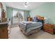 Bedroom featuring carpet, a window, a ceiling fan, and wooden furniture with a comfortable bed at 4691 Mill Pond Rd., Murrells Inlet, SC 29576