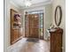 Inviting foyer with tile flooring, a decorative hutch, and a glimpse of natural light streaming through the front door at 4691 Mill Pond Rd., Murrells Inlet, SC 29576