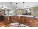 Open kitchen island with granite countertop, and warm wood cabinets, creating an inviting gathering space at 4691 Mill Pond Rd., Murrells Inlet, SC 29576