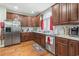 Well-appointed kitchen with wood cabinetry, stainless steel appliances, granite countertops, and a window with natural light at 4691 Mill Pond Rd., Murrells Inlet, SC 29576