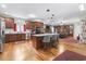 Spacious kitchen featuring wood cabinets, granite countertops, a large island, and an open view to the living area at 4691 Mill Pond Rd., Murrells Inlet, SC 29576