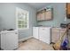 Laundry room featuring a washer, dryer, freezer, cabinets, sink and a window at 4691 Mill Pond Rd., Murrells Inlet, SC 29576