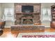 Cozy living room featuring a brick fireplace with a wooden mantel, creating a warm and inviting atmosphere at 4691 Mill Pond Rd., Murrells Inlet, SC 29576