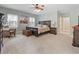 Bright main bedroom with a large bed, warm colors, and a comfortable sitting area with lots of natural light at 4691 Mill Pond Rd., Murrells Inlet, SC 29576
