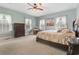 Comfortable main bedroom showcasing a bed, dresser, and plenty of natural light, creating a serene retreat at 4691 Mill Pond Rd., Murrells Inlet, SC 29576
