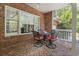 Covered porch with brick flooring and outdoor seating area at 4691 Mill Pond Rd., Murrells Inlet, SC 29576