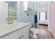 Bright bathroom with gold-toned fixtures, white vanity, and cactus-themed shower curtain at 4827 Orchid Way # 1-203, Myrtle Beach, SC 29577