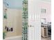 Well-lit bathroom with a shower/tub combo and cactus-themed shower curtain at 4827 Orchid Way # 1-203, Myrtle Beach, SC 29577