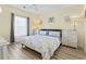 Cozy bedroom featuring a queen-size bed, matching nightstands, and a ceiling fan at 4827 Orchid Way # 1-203, Myrtle Beach, SC 29577