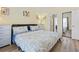 Inviting bedroom with a queen-size bed, natural light, and view of bathroom at 4827 Orchid Way # 1-203, Myrtle Beach, SC 29577
