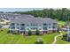 Three-story condo building displays balconies, lawn, and manicured landscaping at 4827 Orchid Way # 1-203, Myrtle Beach, SC 29577