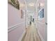 Long hallway with beautiful artwork and wood flooring at 4827 Orchid Way # 1-203, Myrtle Beach, SC 29577