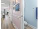 Hallway leading to bathroom with blue wall and a peek into another room at 4827 Orchid Way # 1-203, Myrtle Beach, SC 29577