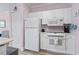 Clean kitchen with white appliances, ample counter space, and adjacent dining area at 4827 Orchid Way # 1-203, Myrtle Beach, SC 29577