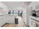 Bright kitchen features white appliances and ample counter space, seamlessly flowing into the living area at 4827 Orchid Way # 1-203, Myrtle Beach, SC 29577