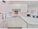 Bright white kitchen features stainless steel sink and views to the living room at 4827 Orchid Way # 1-203, Myrtle Beach, SC 29577