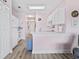 Bright kitchen with white cabinets, appliances, light-pink walls, and wood-look flooring at 4827 Orchid Way # 1-203, Myrtle Beach, SC 29577
