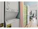 Efficient laundry area with stacked washer and dryer near blue-walled bathroom at 4827 Orchid Way # 1-203, Myrtle Beach, SC 29577