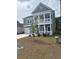 Two-story home featuring a charming porch and clean modern lines offering curb appeal and outdoor enjoyment at 492 Magnolia Terrace Dr, Myrtle Beach, SC 29579