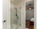 Modern bathroom featuring a glass-enclosed shower, white tile, and sleek fixtures at 4986 Salt Creek Ct., North Myrtle Beach, SC 29582