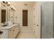 Elegant bathroom with double sinks, granite countertops, framed mirrors, and tile flooring at 4986 Salt Creek Ct., North Myrtle Beach, SC 29582