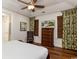 Bright bedroom with a ceiling fan, stylish decor, and a view from the windows at 4986 Salt Creek Ct., North Myrtle Beach, SC 29582